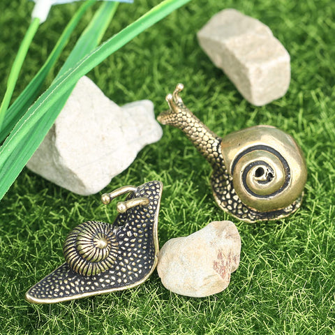 LCCCK brass snail figurine duo adds character to bookshelves or coffee tables.