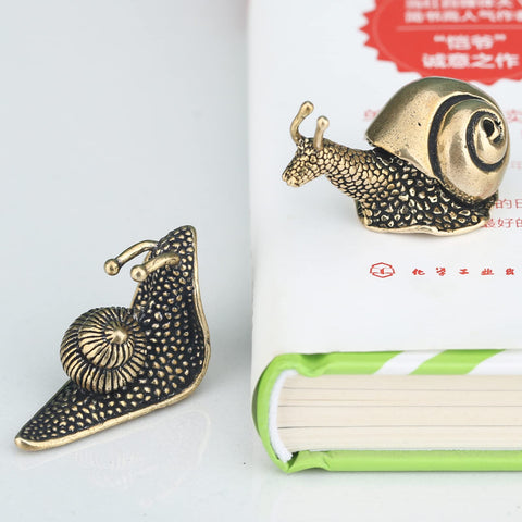 LCCCK brass snail figurine blends vintage charm with modern decor on shelves.