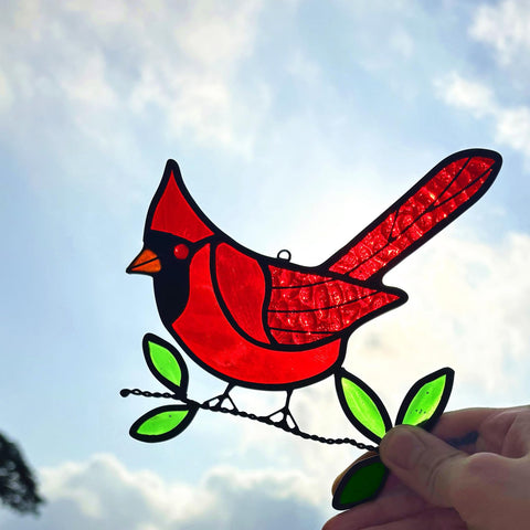 Lcensp red cardinal suncatcher hanging in a sunlit window