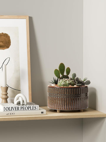 LE TAUCI footed ceramic design enhances air circulation under planters