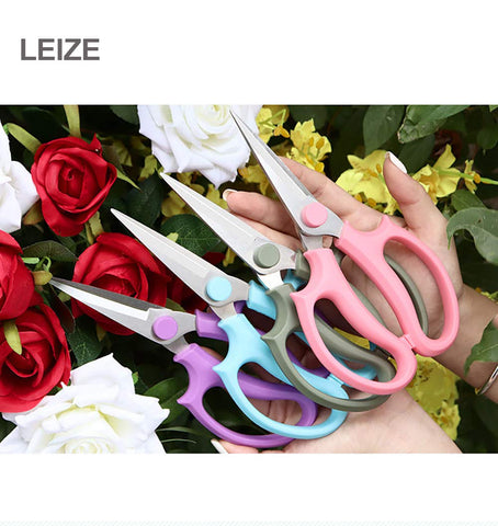 Leize flower scissors in action pruning stems and leaves in a small garden.