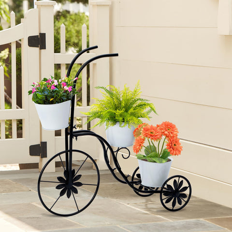 Close-up of tricycle planter wheels showing sturdy outdoor stand