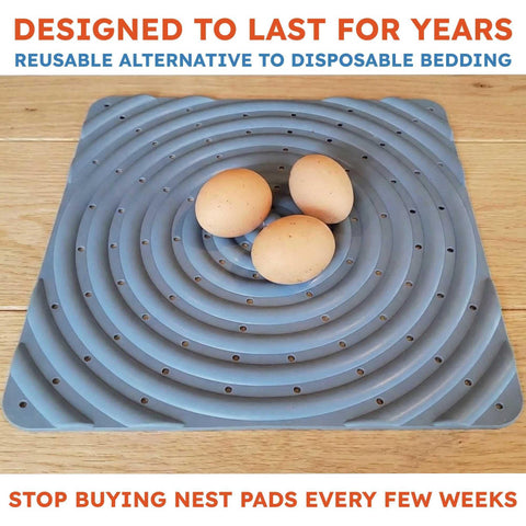 Lil'Clucker washable nesting pad being cleaned with a hose