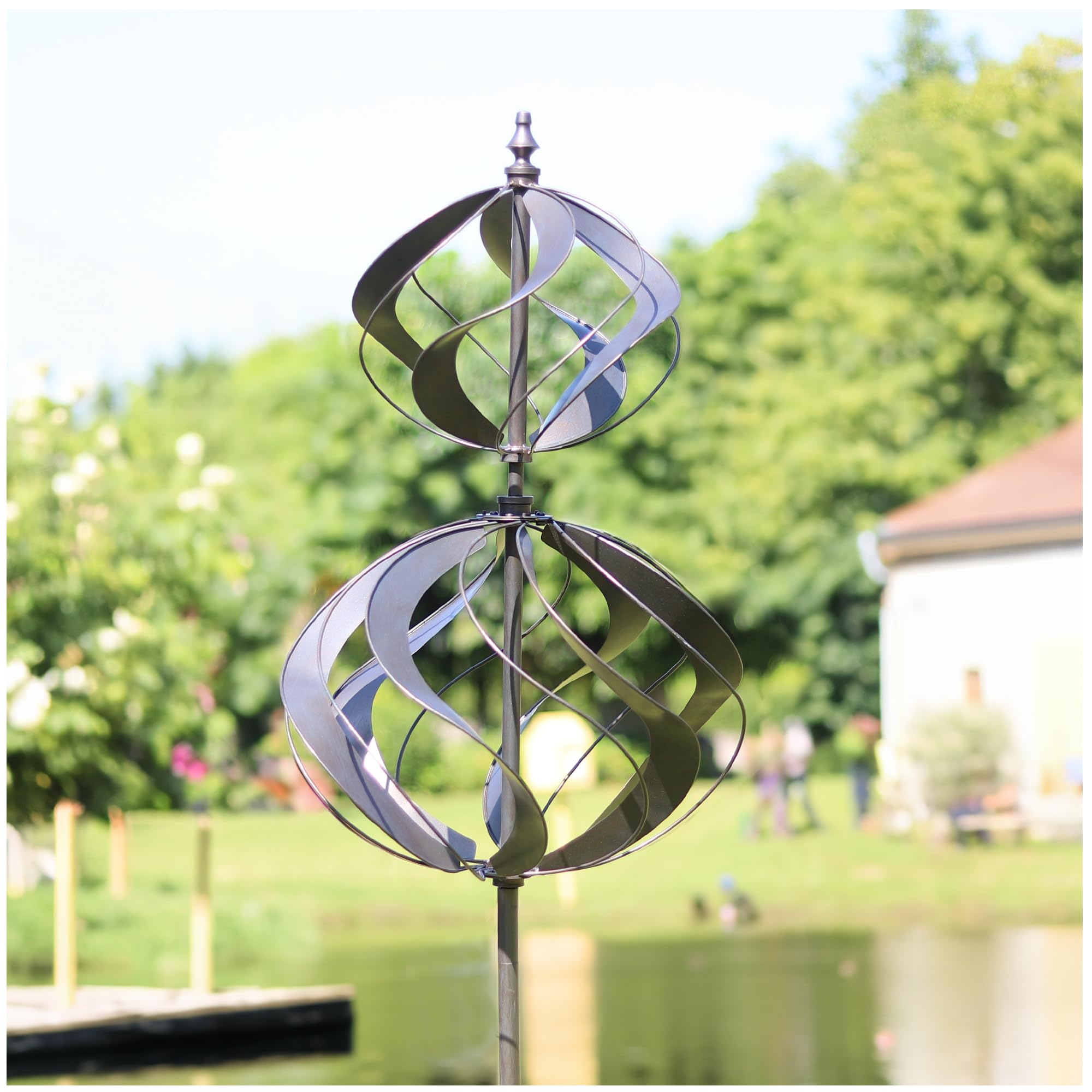 LimeHill wind spinner in silver decorates the yard with kinetic motion.