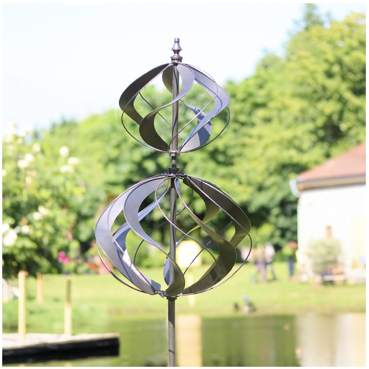 LimeHill wind spinner in silver decorates the yard with kinetic motion.