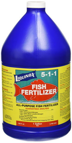 Liquinox fish emulsion bottle pouring onto a garden bed to support growth