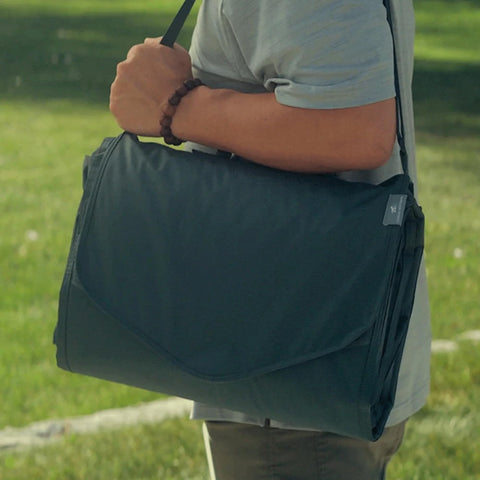 Little Unicorn blanket with shoulder strap for hands-free portability during outdoor trips.