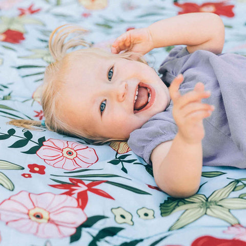 Little Unicorn blanket exterior zip pocket stores essentials securely during outings.