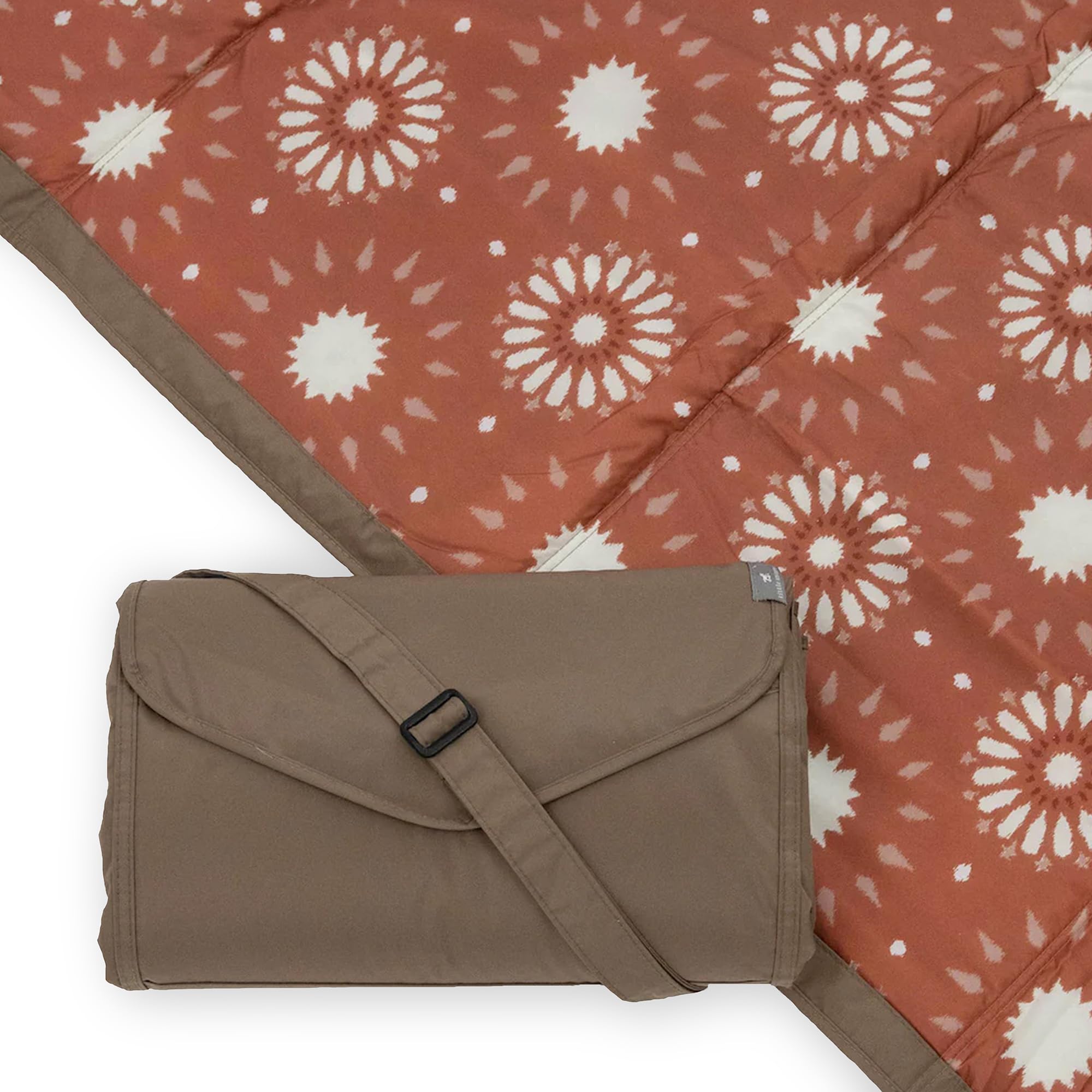 Little Unicorn sun baked picnic blanket folded for easy transport.