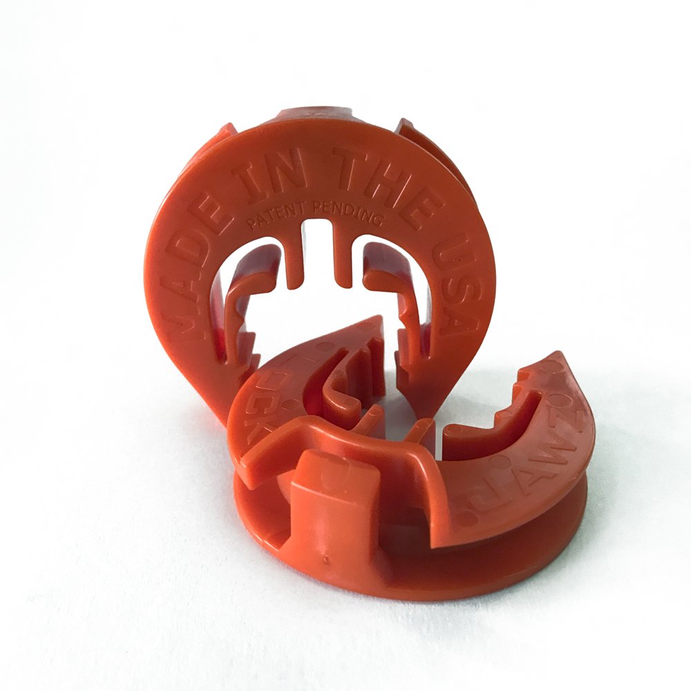 LockJawz orange insulator on a fence post enhances visibility during installs.