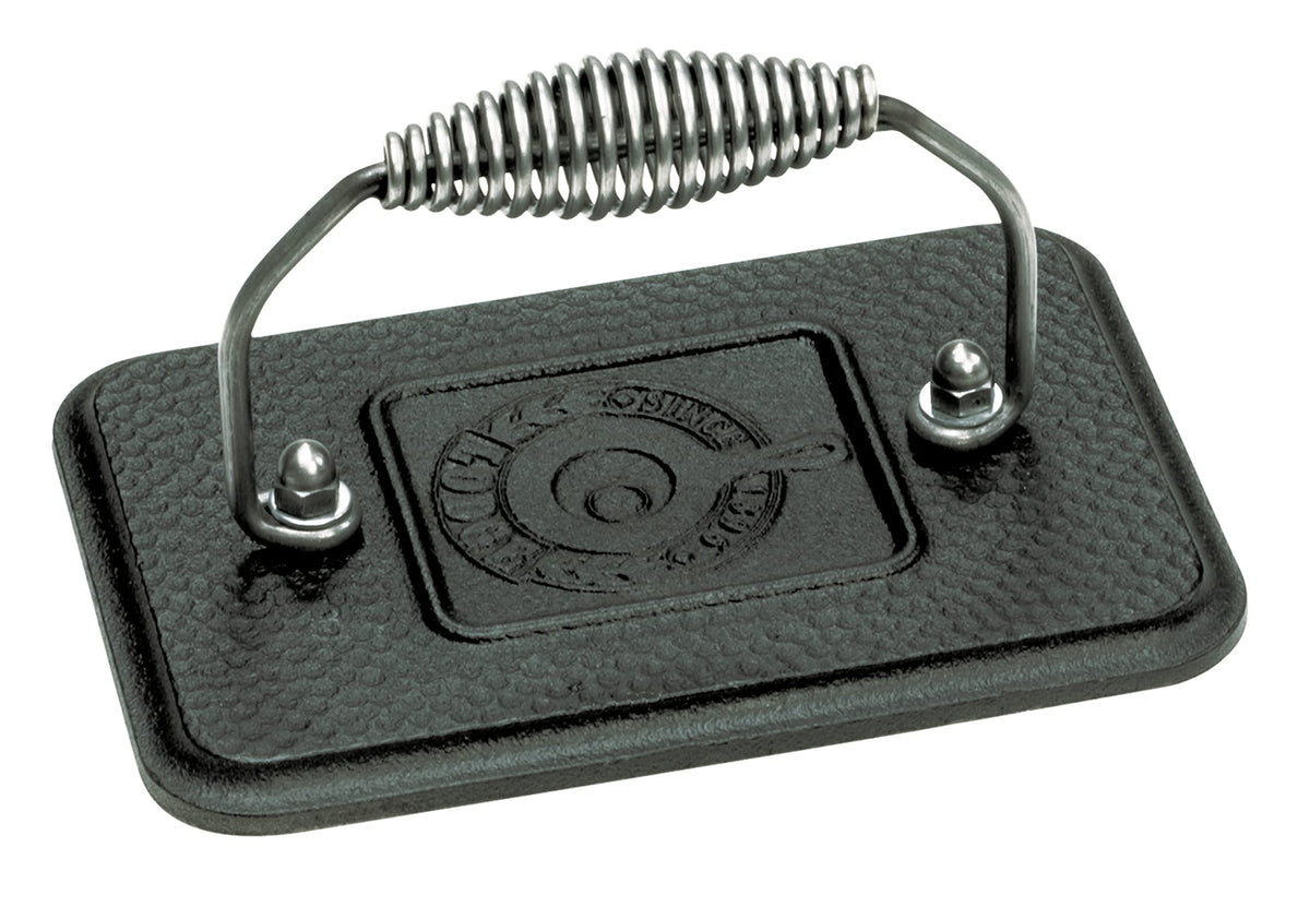Lodge grill press with cool-grip spiral handle for safe, comfortable burgers on the stovetop.