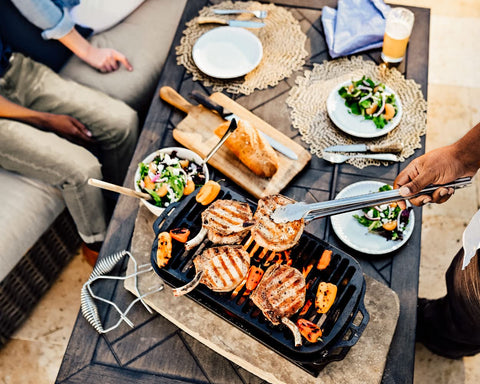 Lodge grill with steel Hook & Carry Handles provides secure grip.