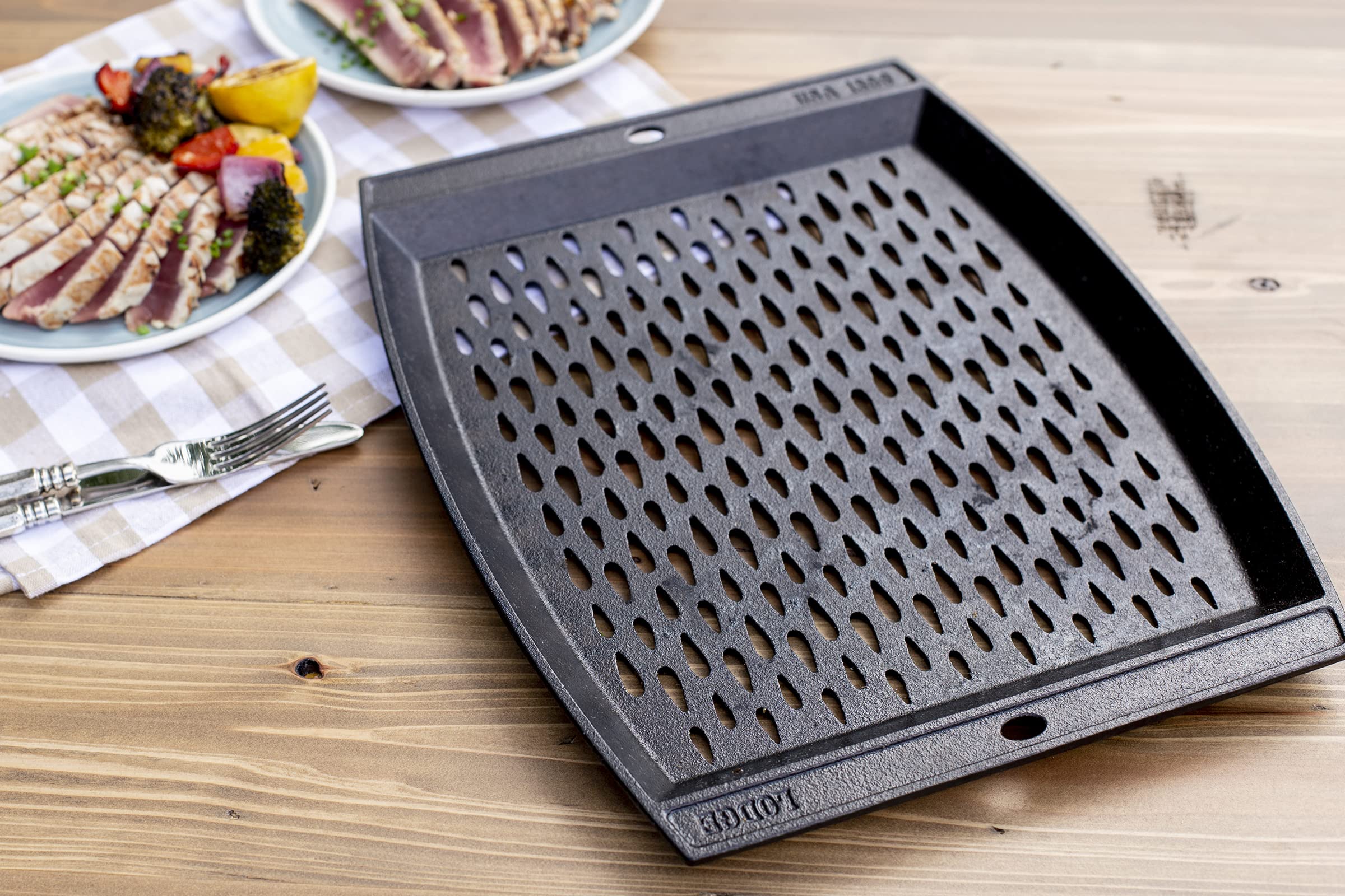 Lodge grill topper features teardrop perforations and even heat for searing vegetables.