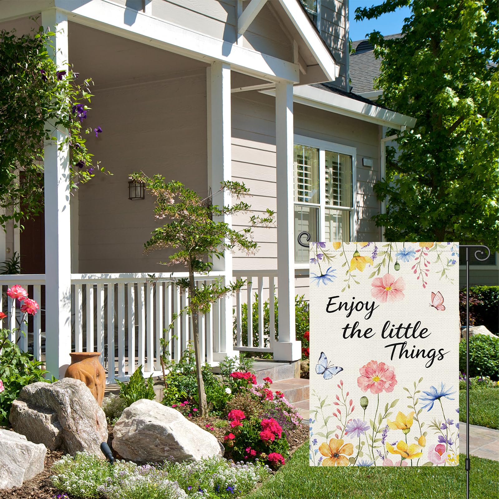 Louise Maelys flag with floral motif enhances garden aesthetics from any angle.