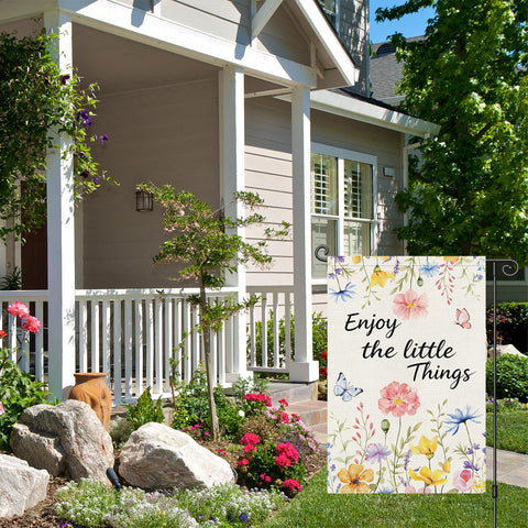 Louise Maelys flag with floral motif enhances garden aesthetics from any angle.