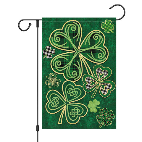 Louise Maelys garden flag displaying a welcome St. Patrick's Day design on a porch.