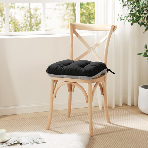 Love's cabin cushions enhance chairs with a sleek black finish.