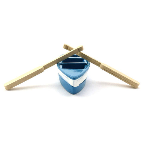 LQ Industrial plastic boat with oars for cake toppers or displays.