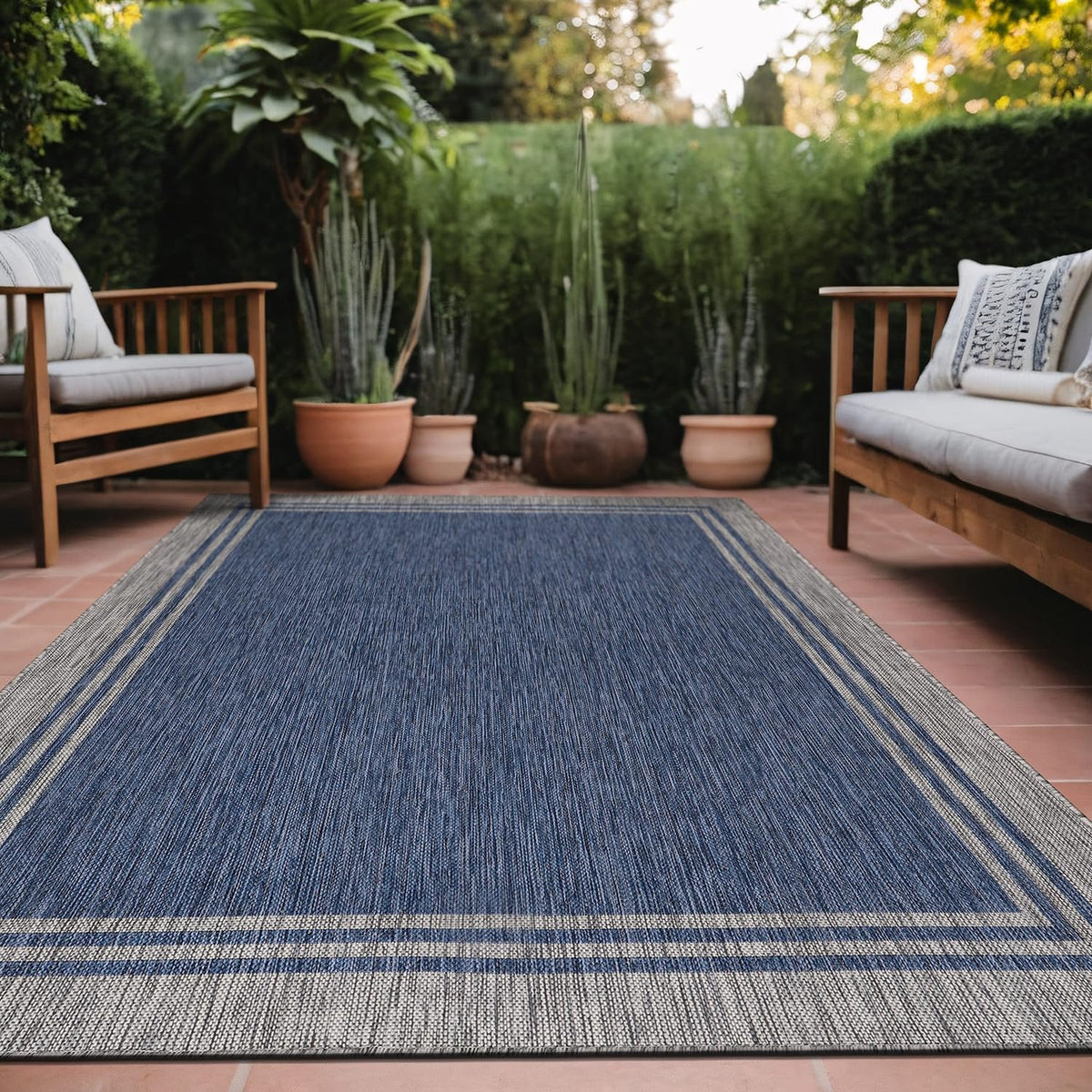 Luul Home bordered outdoor rug 9x12 navy, durable and washable for patios.