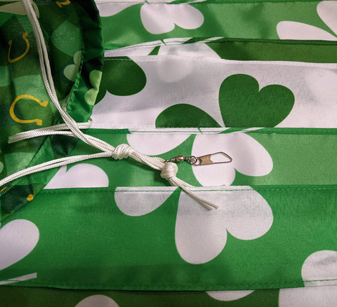 Madrona Brands plaid-background-clover-windsock adds classic pattern and festive flair to yard spaces.