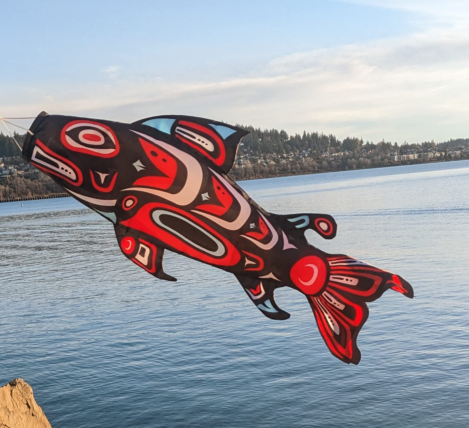 Madrona Brands Totem Salmon Windsock bold patterns enhance garden appeal.