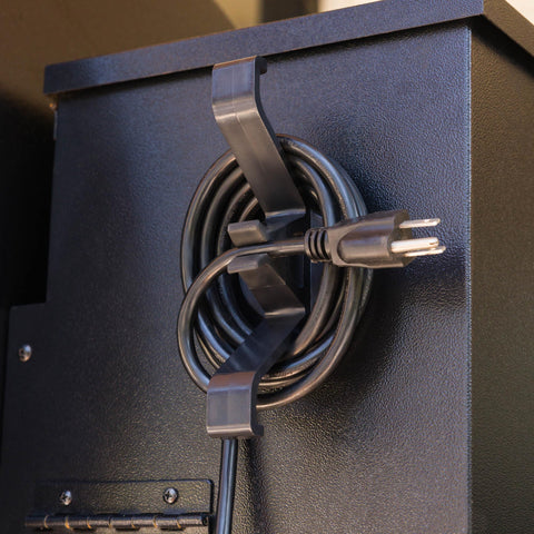 Magna Outdoors cord organizer attached to wood pellet grill securely holding the cord in place