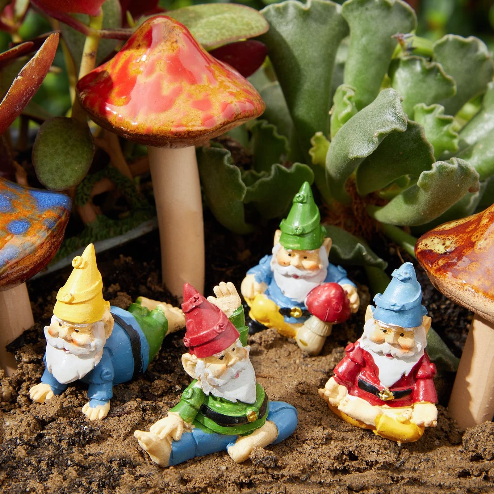 Humorous gnomes in playful poses brighten front yard or fairy garden