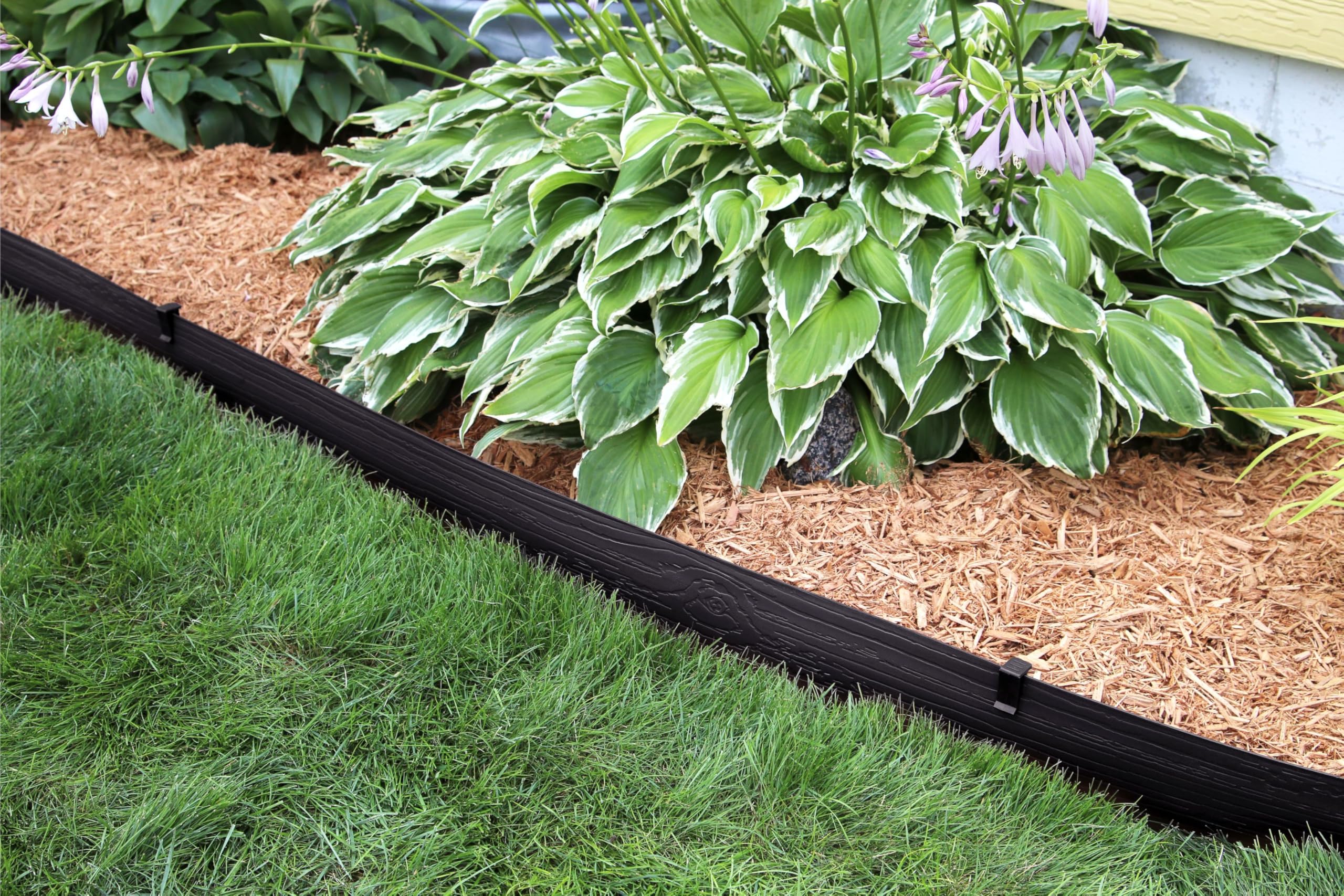 Master Mark terrace board edging showcases wood-grain finish blending with outdoor spaces.