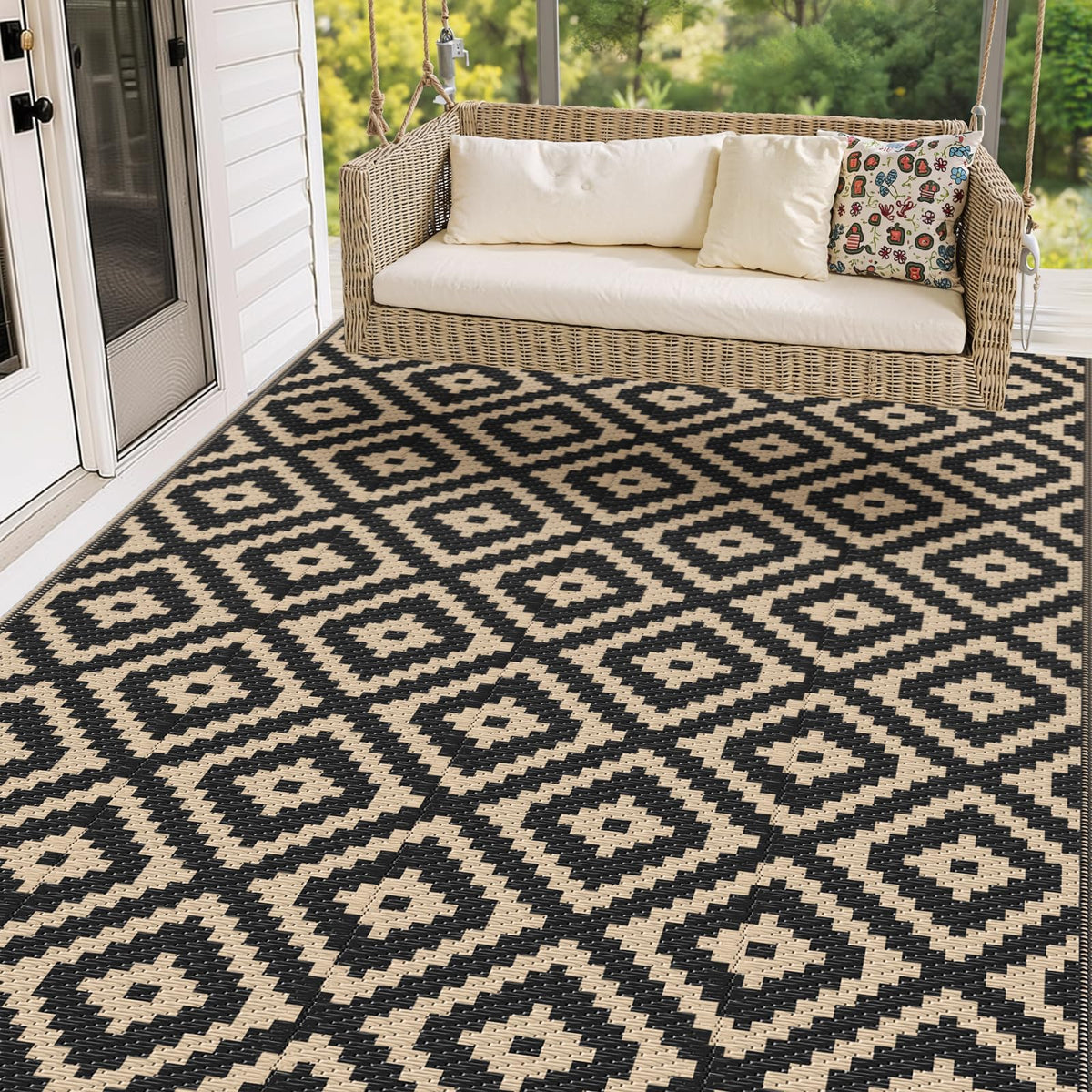 Mattitude 5x8 outdoor rug on patio, black and beige, weather-ready.