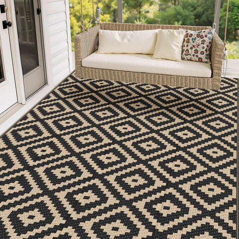 Mattitude 5x8 outdoor rug on patio, black and beige, weather-ready.