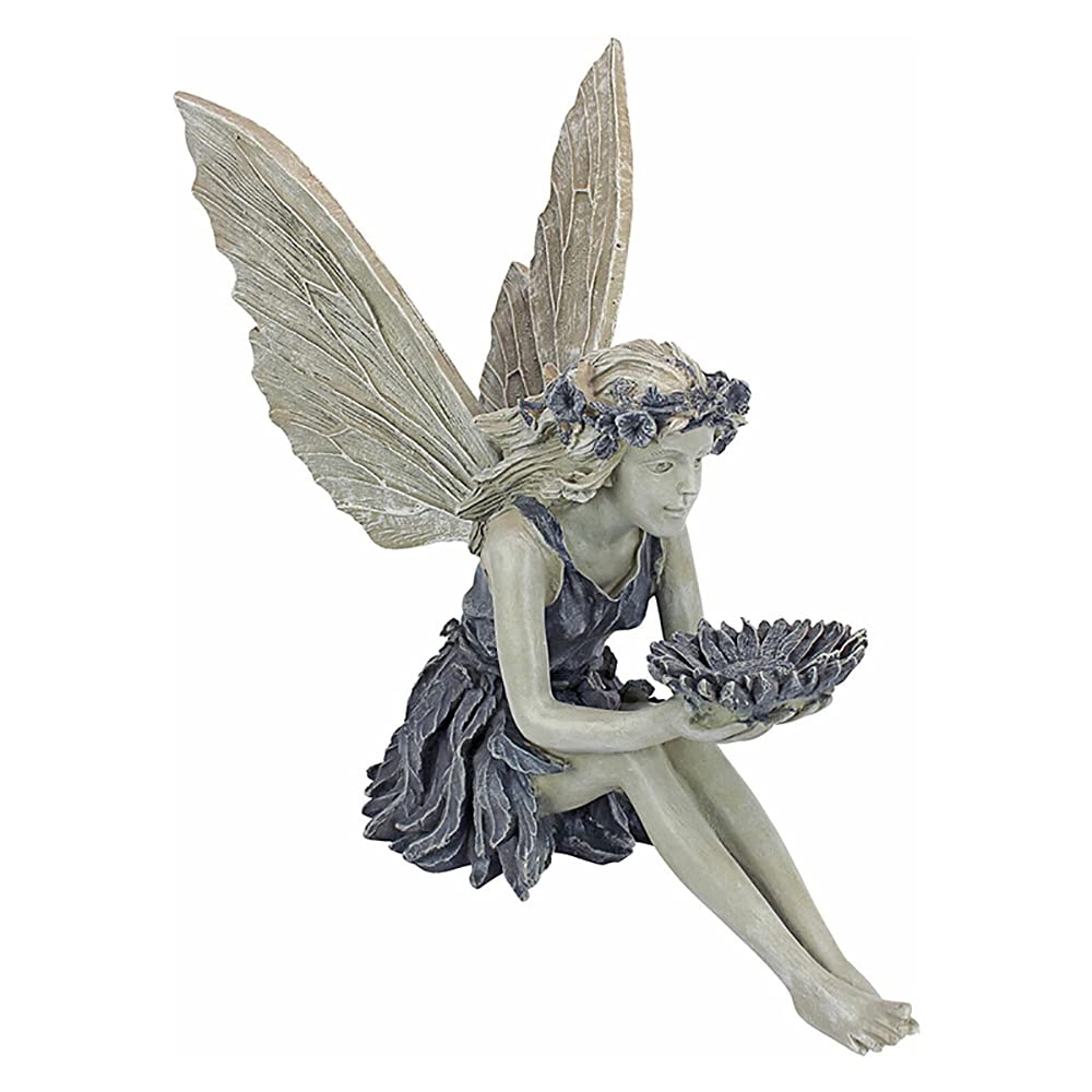 MBVBN fairy statue sits on a window ledge, brightening shelves with whimsy