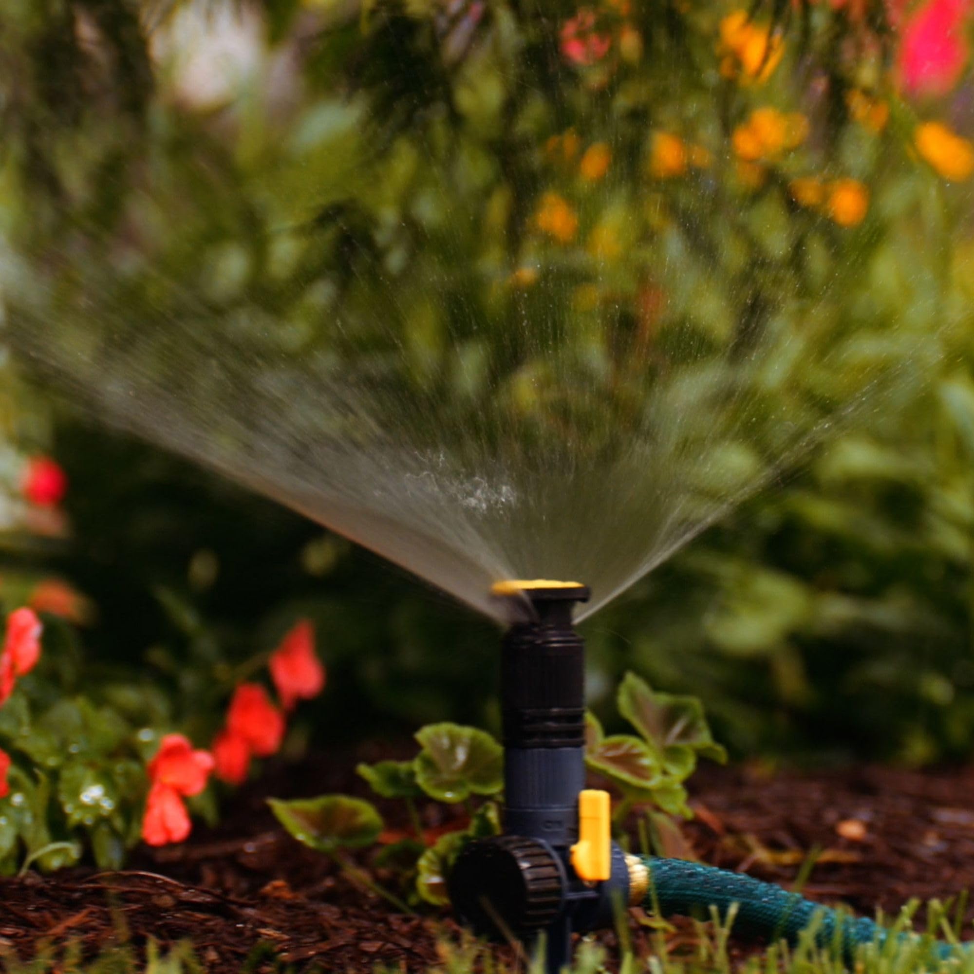 Melnor 65185AMZ close-up shows the spray nozzle and even coverage.