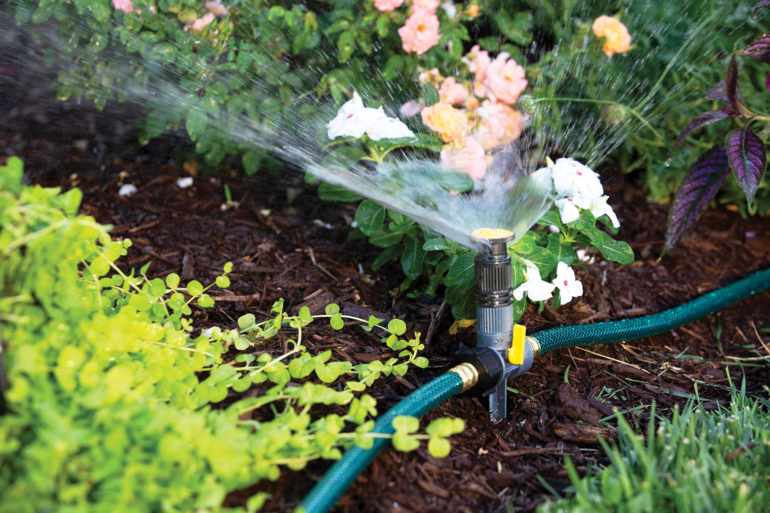 Melnor sprinkler with angle control enables targeted watering around garden beds