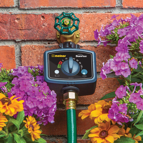 Melnor Sunrise timer dial highlights adjustable watering duration for garden schedules.