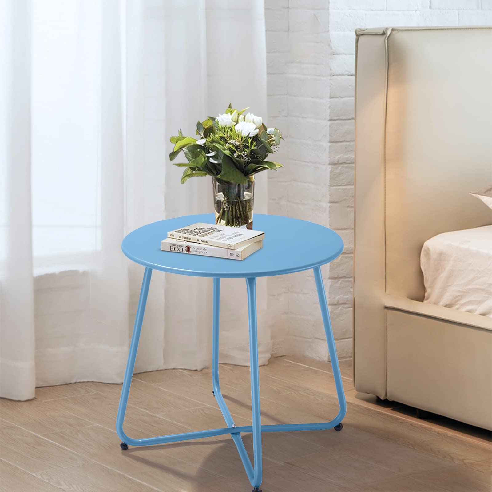 Meluvici blue round-top patio table beside cozy balcony chairs.