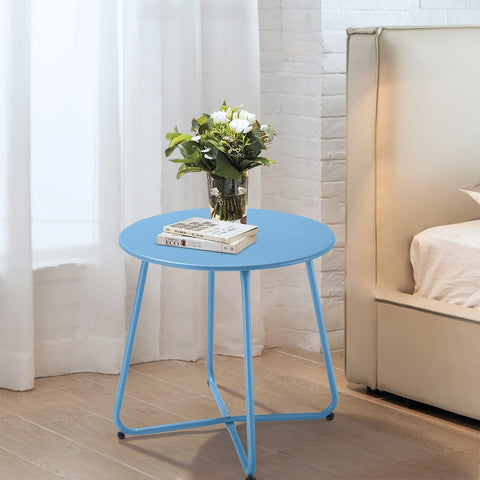 Meluvici blue round-top patio table beside cozy balcony chairs.