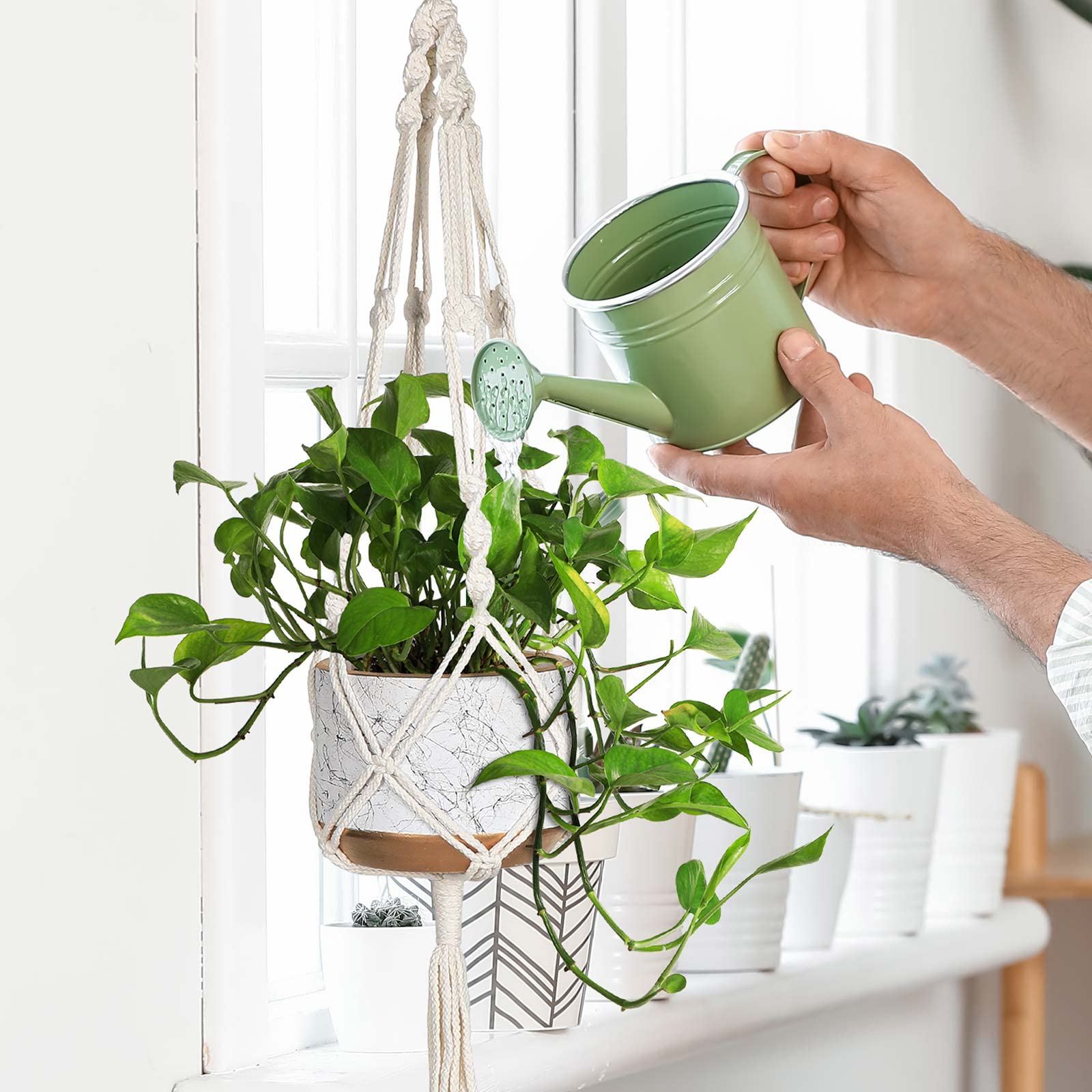 MIPON 41-inch ivory macrame plant hanger with a mid-size pot on a balcony
