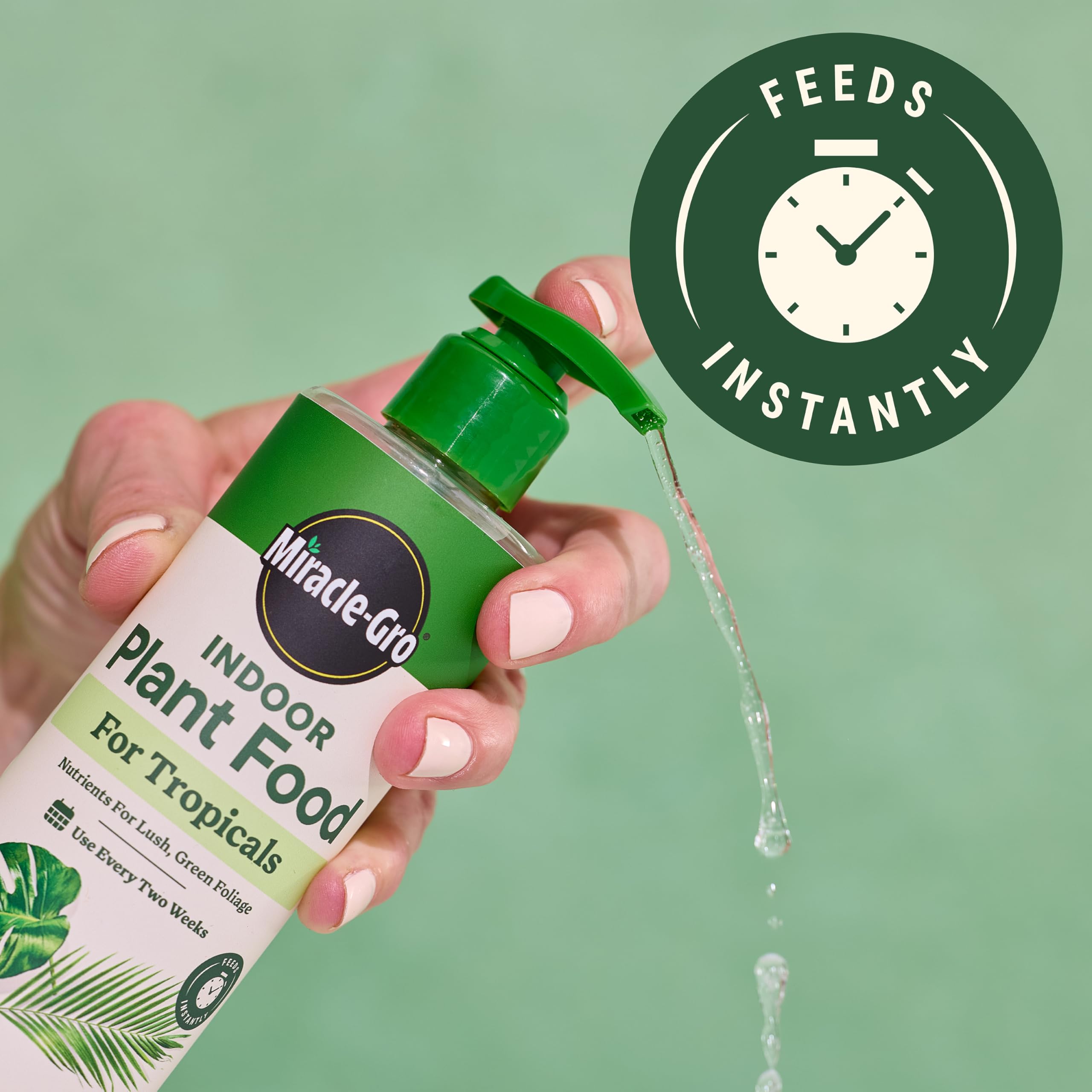 Miracle-Gro Indoor Plant Food Tropicals bottle pour demonstrates instant feeding for greens.