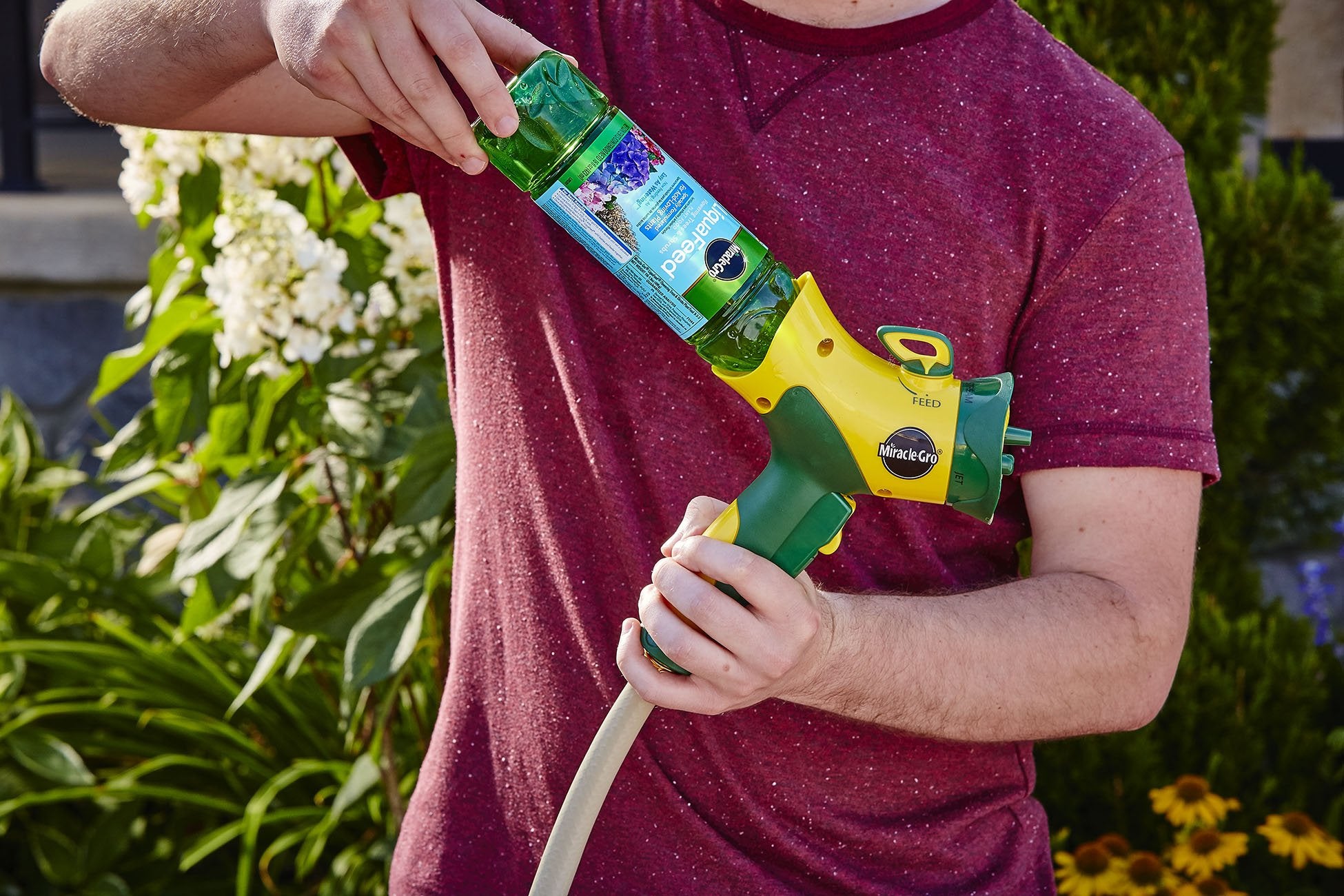 Miracle-Gro LiquaFeed being used in-ground and in containers for plant growth.