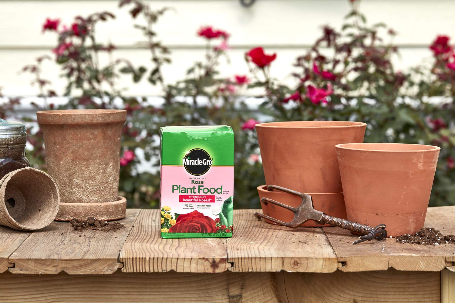 Outdoor garden bed receiving Miracle-Gro feed every 7-14 days.