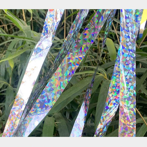 Ribbon fluttering in sunlight with bright reflective flashes.