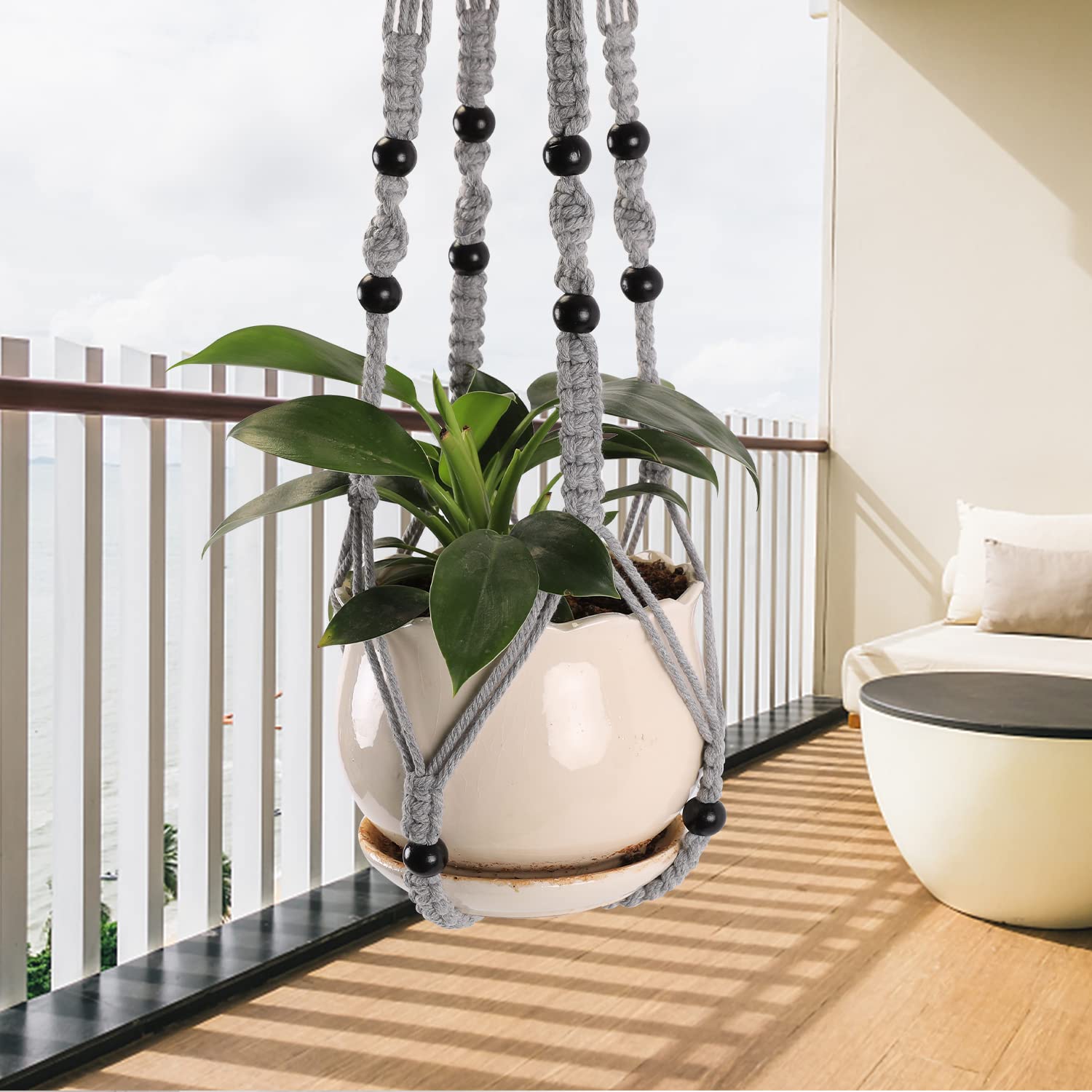 MKO SHUN macrame plant hanger gray bead detail adds decorative texture to room.