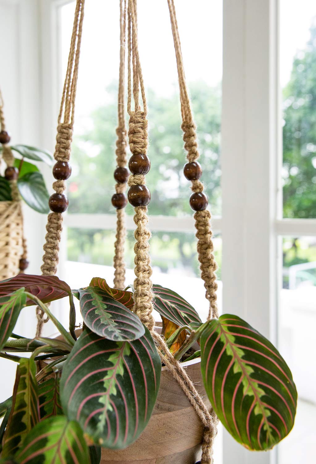 Mkono 35-inch macrame hanger in living room adds natural texture.