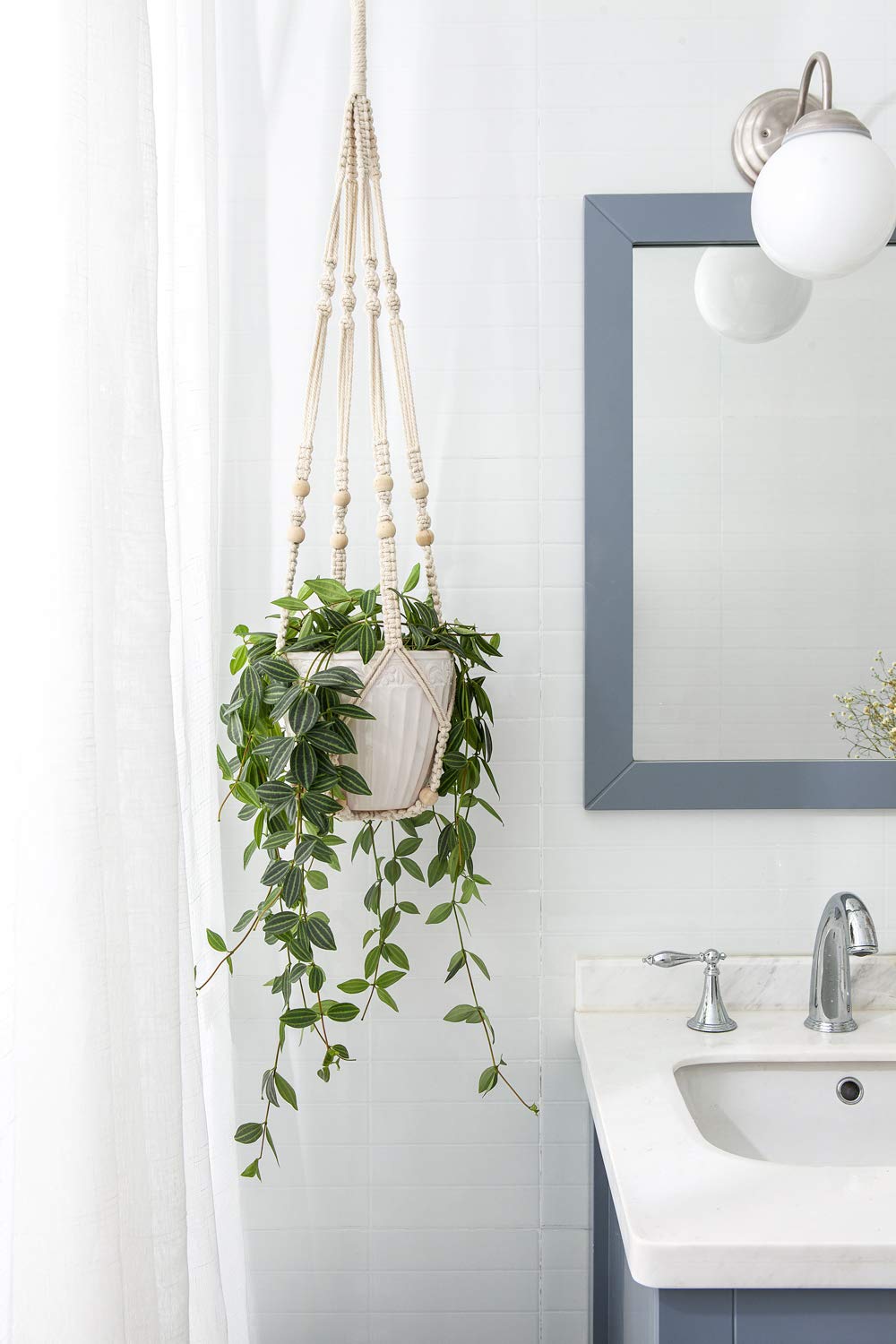 Mkono ivory hanger displayed with plant on balcony or patio.