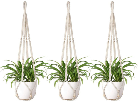 Mkono macrame plant hanger ivory with wood beads adds boho chic to indoor spaces.