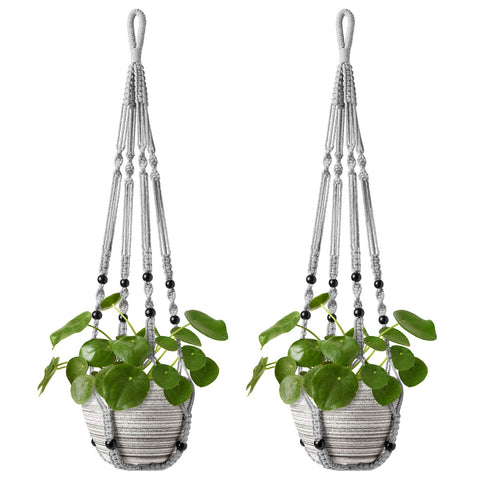 Mkono macrame plant hanger with wood beads adds vintage charm, elevating decor.