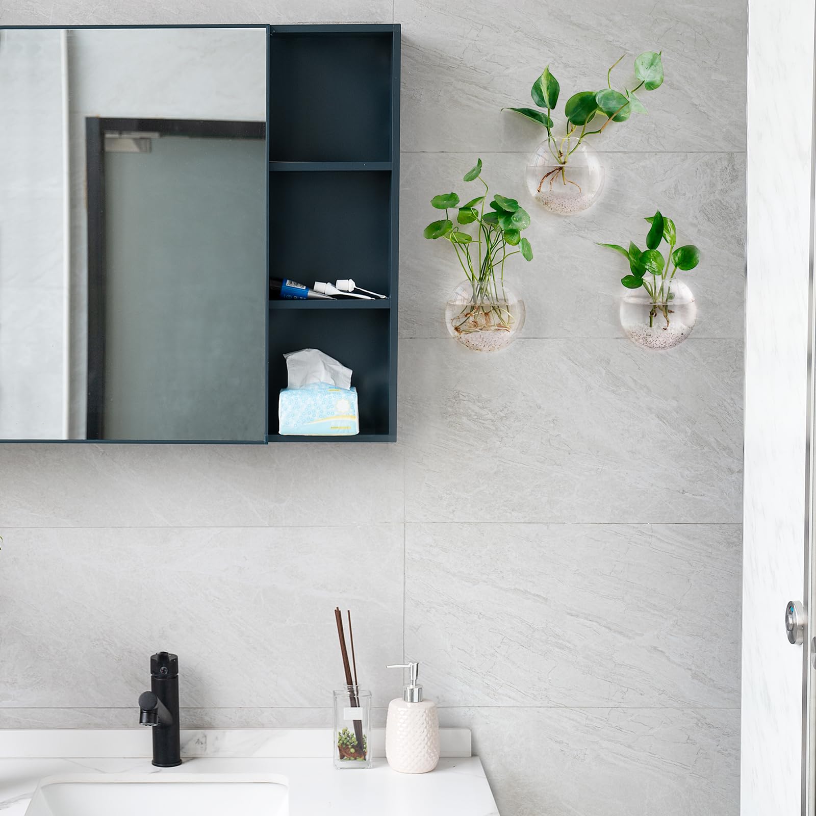 Mkono oblate vases highlight water plants with reflective light.