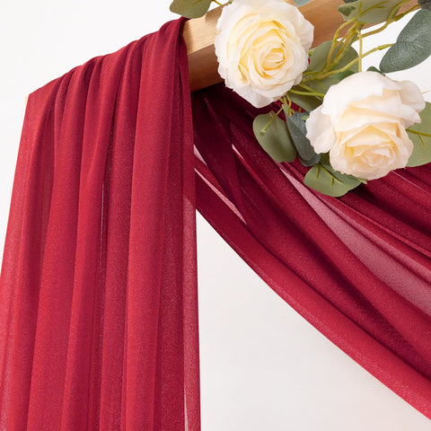 MLMC red wedding arch draping fabric hanging gracefully to create a romantic backdrop.