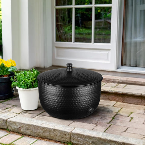 Monarch Abode hose holder with hand-hammered finish adds decorative texture and weather resistance.