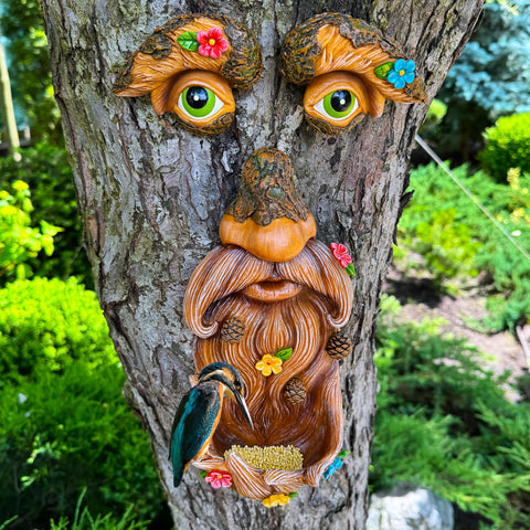 Mood Lab Tree Face Decor with flowers enhances garden color and character.